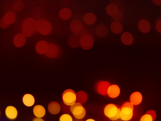 Abstract background defocused lights bokeh dark red yellow black.