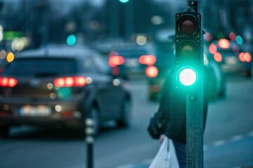 traffic light on the street junction with beautiful bokeh, city with cars in the background