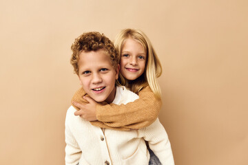 brother and sister friendship rides on the back childhood beige background