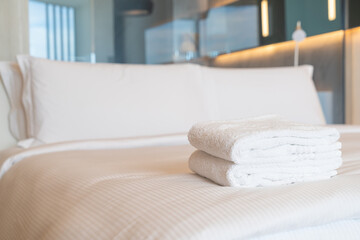 white shower towel on bed