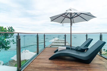 Obraz premium bed pool with umbrella around swimming pool