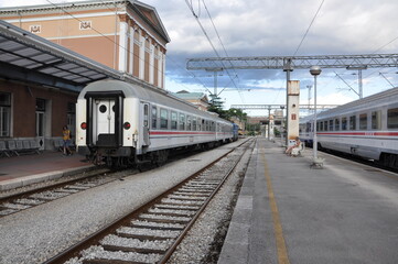 RIJEKA, CROATIA - 07.21.2020: Main railway station and white passenger train in Rijeka during summer holiday. Train on the railway station.