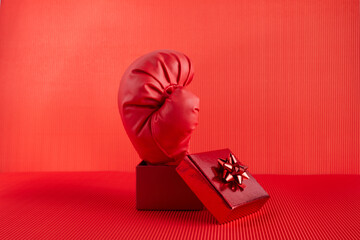 Boxing day shopping creative idea. Boxing glove coming out of gift box.