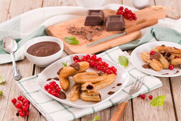 Mini churros with chocolate dipping sauce.