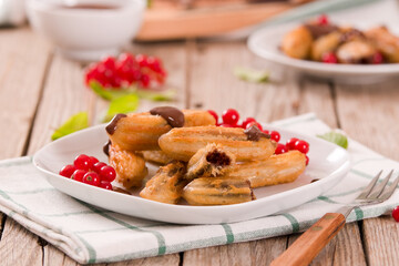Mini churros with chocolate dipping sauce.