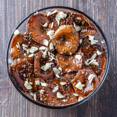 Sliced preserved mushrooms in bowl on table.Marinated mushrooms with pepper and bay leaf. Top view.Natural vegetarian food from the forest.