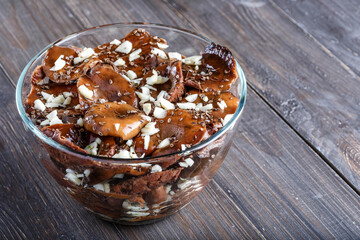 Sliced preserved mushrooms in bowl on table.Marinated mushrooms with pepper and bay leaf. Top view.Natural vegetarian food from the forest.
