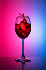 a glass of red wine on a two-tone background