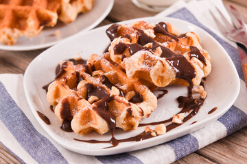 Waffles with chocolate cream and hazelnuts.
