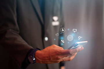 Business people who use smartphones, mobile phones and icon network connection data with customers.