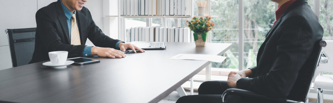 Businessman in formal suite interviewing candidate at office
