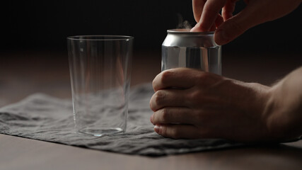 man hand open can with drink on wood table