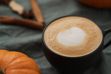 Pumpkin spicy latte in black cup on linne cloth