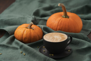 Pumpkin spicy latte in black cup on linne cloth