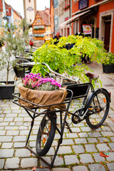 Fototapeta na wymiar Germany, Rothenburg, fairy tale town, old streets, businesses, bicycles, flower baskets