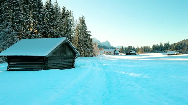 Winter wonderland, Fantastic winter landscape with wooden house in snowy mountains. Kr&uuml;n germany europe 4K sun light rain. Alps mountain