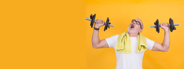 Portrait of senior man exercising with dumbbells