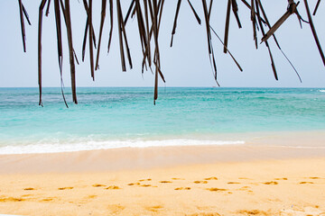Fototapeta na wymiar Beach by the ocean with yellow sand in the tropics.