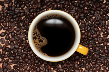 top view, bubbles and water surface of hot coffee in yellow cup , cappuccino, espresso in cup and coffee beans on wooden table . monday morning concept.