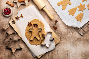 Cooking Christmas cookies, gingerbread man with cutter. Made with hazelnut butter. Christmas and New Year traditions concept, view from above, copy space.
