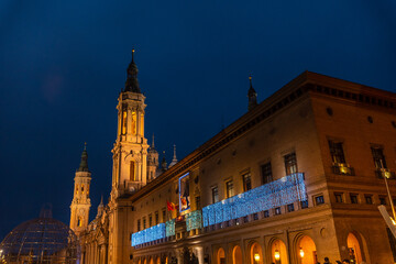 Towers illuminated at night in the Basilica of Our Lady of the Pillar in the city of Zaragoza, next to the Ebro river in Aragon. Spain