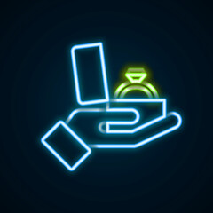 Fototapeta premium Glowing neon line Diamond engagement ring in a box icon isolated on black background. Colorful outline concept. Vector