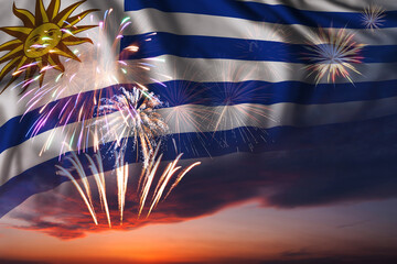 Fireworks in evening sky and flag of Uruguay