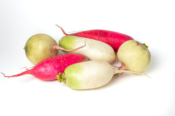 Different varieties of radish on a white background. Long red radish next to a white radish. Delicious and healthy vegetables. Vegetarian food.