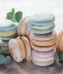Beautiful colorful tasty macaroons on a concrete background