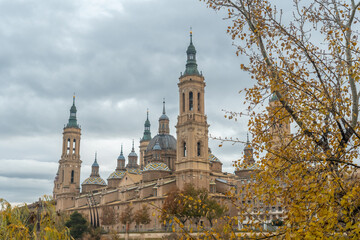 Fototapeta premium Towers of the Basilica de Nuestra Señora del Pilar from the Ebro river in the city of Zaragoza, Aragon. Spain