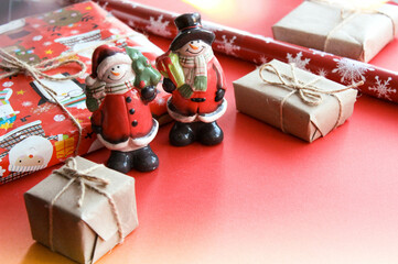 Christmas and New Year decorations mock up or flat lay on red background. Gifts, garland, snowman. Winter, New Years holidays concept as top view, copy space. greeting card template. Place for text