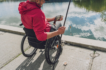 Person with a physical disability in a wheelchair fishing from fishing pier.