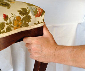 Craftsman repairs the upholstery of an antique chair. Furniture restorer