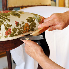 Upholsterer repairs an antique chair. Furniture restorer 
