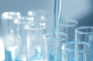 Scientific laboratory research and experiments. Laboratory test tubes close up with blue liquid, selective focus.