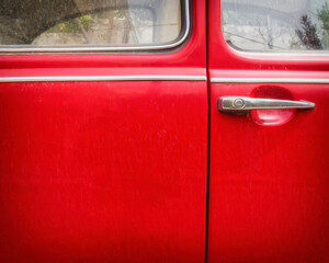 vivid red car door and chrome handle, space for your text