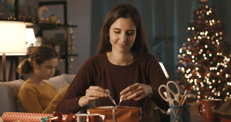 Woman preparing Christmas gifts at home