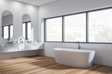 Corner view on bright bathroom interior with two sinks, bathtub