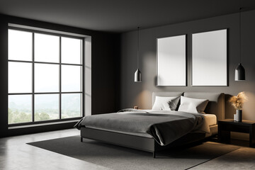 Two white canvases in panoramic dark grey bedroom. Corner view.