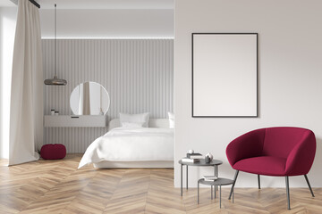 Bright bedroom interior with empty white poster, bed, armchair, mirror