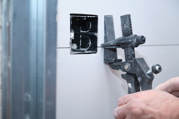 Close up of a constructor worker hand adjusting the separation between tiles.