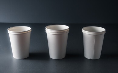 white mock up disposable cup or goblet for branding on grey rustic background .