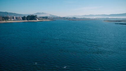 View of the Lima river at morning from the Eiffel bridge in Viana do Castelo, Portugal.