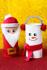 Handmade craft project from toilet tube. Creative kids DIY New year. Cute Snowman and Santa for Christmas party.