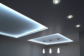 stretch ceiling with chandelier and lamps