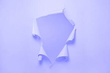 Ripped Paper Hole with purple coloured background Very Peri. Torn hole in  paper, ripped edges. Long wide banner. Copy space for your design. Color of the Year 2022