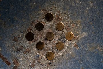 background of holes cut into a metal surface with traces of rust, detail for industry
