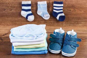 Stack of clothing for baby boy, extending family concept