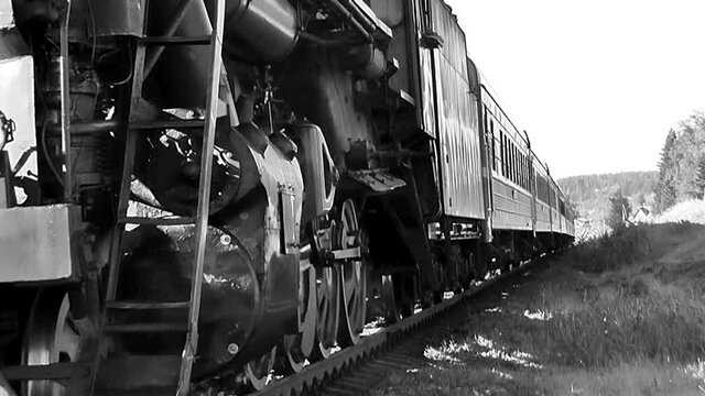 Retro train on steam locomotive traction black and white video. Tourist vintage steam train plying the route Sortavala - Mountain Park "Ruskeala&ndash; - Sortavala in Karelia, Russia.