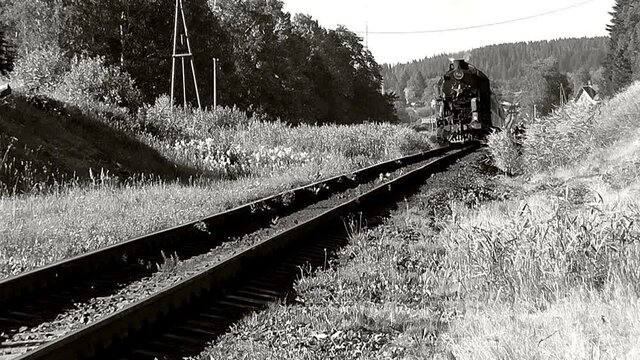 Retro train on steam locomotive traction black and white video old movie.  Tourist vintage steam train plying the route Sortavala - Mountain Park "Ruskeala&ndash; - Sortavala in Karelia, Russia.